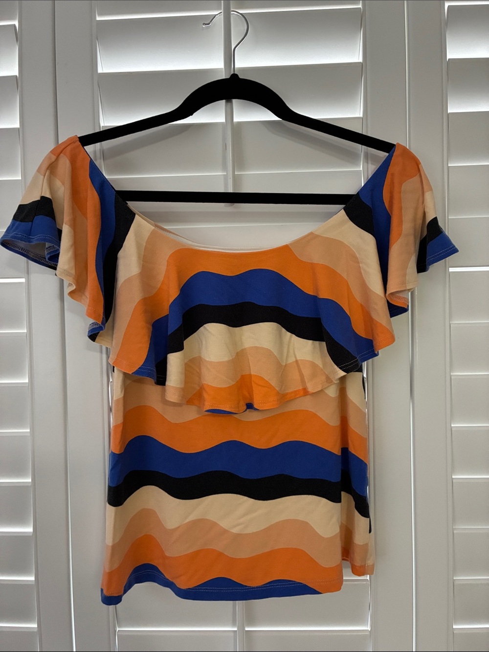 Fighting Eel Women’s Off-Shoulder Ruffle Top in Orange, Blue, and Cream
